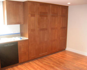 Lots of storage in this area, thanks to tall pantry cabinets, basement kitchen remodel
