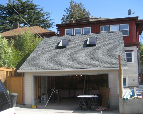 After: a new two-car garage with storage, and beyond, a complete basement remodel that can be used for relatives or a rental, garage builder seattle
