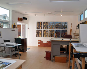P's studio, while technically a daylight basement, is truly filled with light, from windows and doors to the South and clerestory windows to the North.  The West wall was left purposely windowless to allow art pieces to be hung and worked on there.