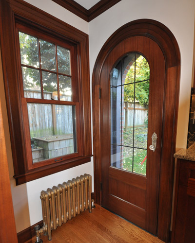 This custom replacement door is built from mahogany, including the curved jamb and casing, with double pane leaded glass.  With the new door installed, it's hard to imagine it being any other way
