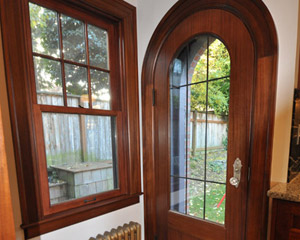 This custom replacement door is built from mahogany, including the curved jamb and casing, with double pane leaded glass.  With the new door installed, it's hard to imagine it being any other way