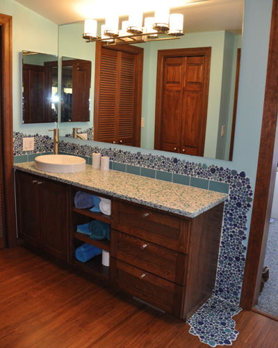 This bathroom facelift - no walls were moved - is both value-priced and makes a huge difference in how the bathroom looks and feels.  It's now a cool and colorful oasis.