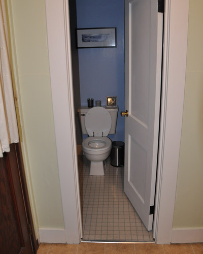 The reconfigured bath includes a pocket door in a new location rather than the old swing door, since space was so tight