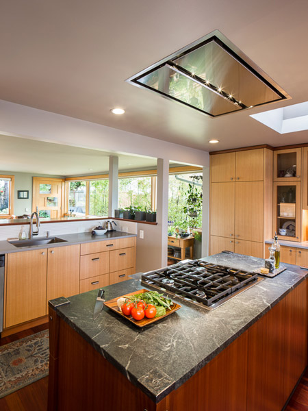 The island stove employs an unusual flush-mount hood for ventilation.  This was chosen to avoid blocking the expansive view of the Olympics from that spot in the kitchen