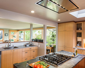 The island stove employs an unusual flush-mount hood for ventilation.  This was chosen to avoid blocking the expansive view of the Olympics from that spot in the kitchen.