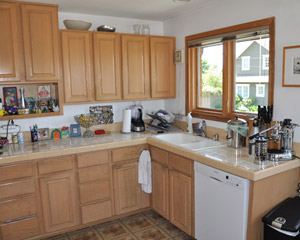 Before: the dividing wall was big on cabinet space but not great on design, with the kitchen sink wedged into the corner