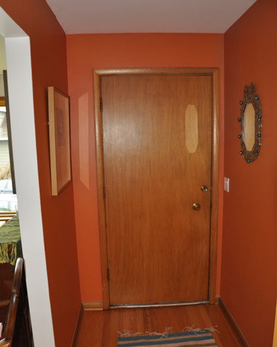 Before: the entry door is delaminating and in need of an update