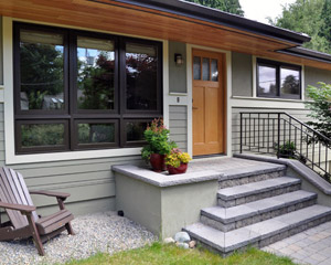 The porch is anchored by a custom steel railing that is duplicated at the sidewalk entry to the home--a unique design feature that really sets this project apart.  All of the wood interiors of the windows were finished with a low-VOC finish--Osmo Polyx Oil.  Other low- and no-VOC finishes were used in other locations
