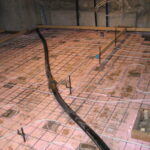 The basement was dug down, then insulation and radiant heat added before the new slab was poured.