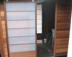 An area under the deck at the main house becomes an enclosed potting shed, thanks to these custom-made Shoji doors