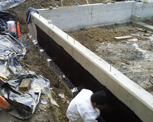 Substantial foundation work was required, including re-pouring parts of the existing foundation where it was inadequate.  It turns out that the existing house is now much more stable, thanks to the basement remodel