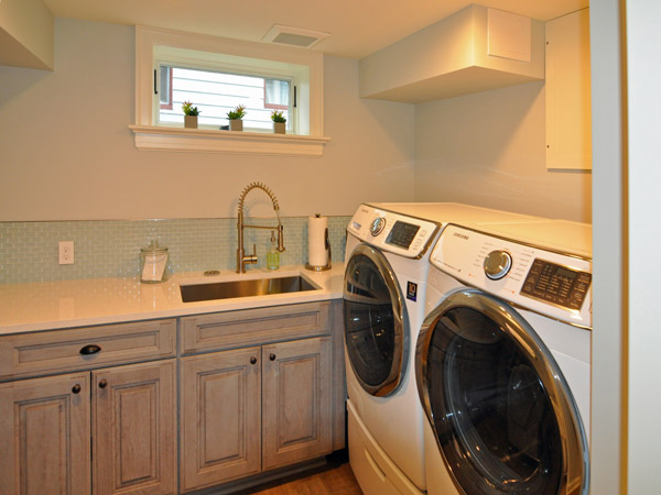 Laundry room with sink in basement