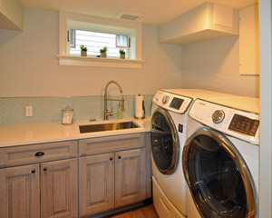 Laundry room with sink in basement