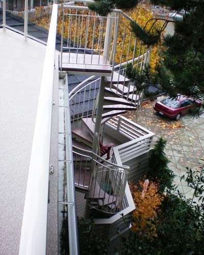 The new stairs have masonry steps for aesthetics and function.  A middle 'resting step' gives a chance to catch your breath on the way up.  The landing at the bottom is a small addition on the main floor deck