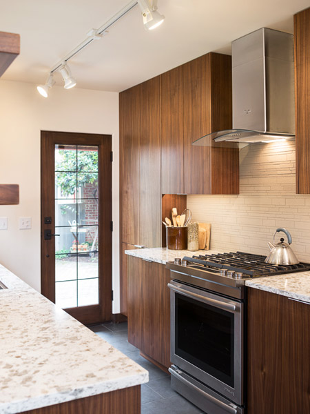 The same cabinets are used in multiple locations to create storage and a bar area