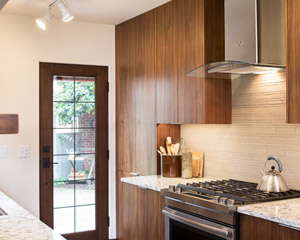 The same cabinets are used in multiple locations to create storage and a bar area