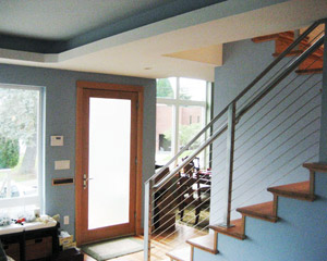 The Kolbe and Kolbe entry door has frosted glass for privacy, and leads directly to the stairs to the second floor