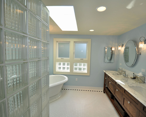 The centerpiece of the remodel is this spa-like bath.  Accents of glass block at the shower and window, with frosted glass on the operating windows keeps this new master bath light and bright and private at the same time.  The central skylight brings in additional glow to this serene space