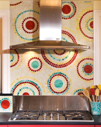 The star of the show is the hand-cut mosaic glass tile, designed and crafted by one of the owners.  The swirls of color compliment the multi-colored cabinets, kitchen tile ideas Seattle