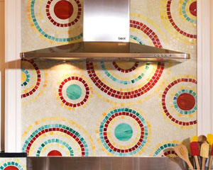The star of the show is the hand-cut mosaic glass tile, designed and crafted by one of the owners.  The swirls of color compliment the multi-colored cabinets, kitchen tile ideas Seattle