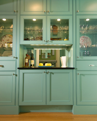 The custom cabinets have the same unique bead detail on the doors.  The small counter area is perfect for serving drinks during parties