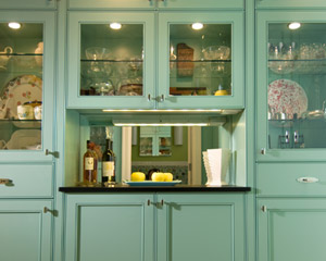 The custom cabinets have the same unique bead detail on the doors.  The small counter area is perfect for serving drinks during parties