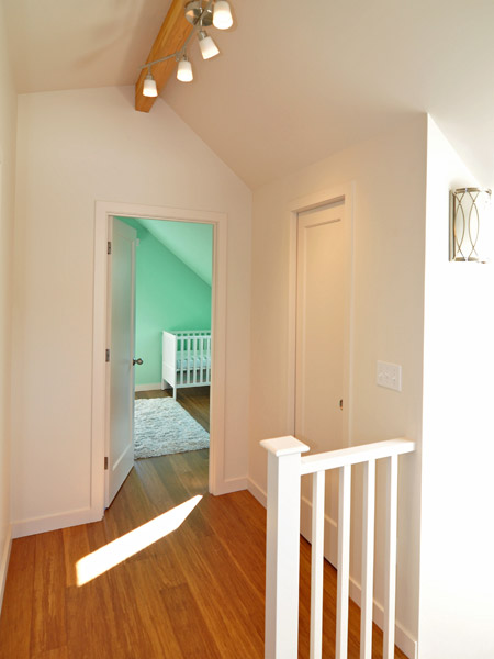 The other key element of this project was installing a new ridge beam in place of the old 1x4 ridge along the entire roof line. This allows the ceilings to be vaulted throughout. Left exposed, the beam also brings nice natural wood color to the rooms, which are otherwise painted