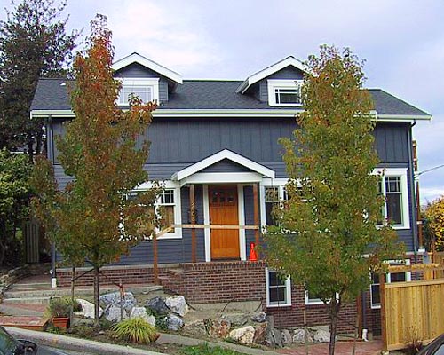 A classic look: brick at the foundation, with board and batten at the second story remodel Capitol Hill