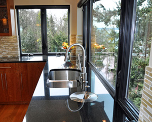 Composting is made easy with the in-counter bin, finished on the top with a stainless steel plate. Kitchen remodel Seattle