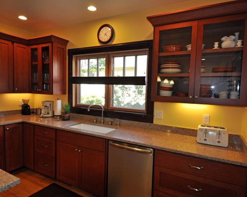 Custom cherry cabinets are stained a deep red, reflecting the warm, rich paint colors throughout the home