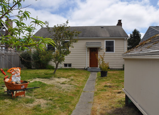 Classic War Box:  two bedrooms and a bath on one end, living room and kitchen on the other, with an unfinished basement and laundry area below.  With such a small footprint, there's plenty of room to add on, particularly once the chicken coop is removed