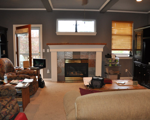 The trip upstairs from the front door used to conclude with this view of the living room: a wall of fireplace punctuated by two windows and a door. It was clear those openings were intended to bring light into the room, but not enough, particularly with the dark paint and furniture, and carpeting. The experience was like arriving in a dark basement room, not a main floor living area