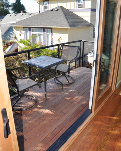 By removing that fireplace, it allowed the entire deck to be resurface and now accessed via the sliding doors. New steel stringer railings bring a contemporary upgrade and lacewood decking is a visual counterpoint to the poplar flooring inside
