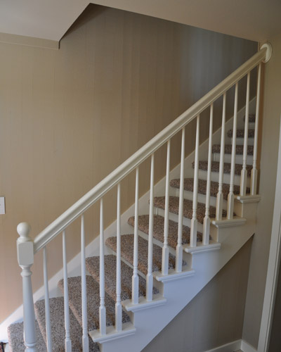 The previous design had paint grade railings and carpeted stairs that weren't to code