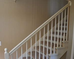 The previous design had paint grade railings and carpeted stairs that weren't to code