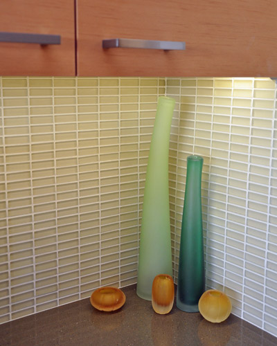 Etched glass tile by Ann Sachs at the backsplash glows beneath the under-cabinet lighting. Kitchen tile ideas seattle