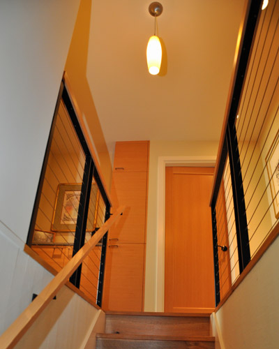 At the top of the new stairs is a small linen cabinet and counter tucked into the hallway