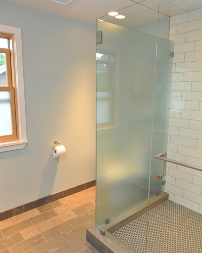 The shower is spacious, and the glass surround designed to obscure the view of the toilet when entering the room