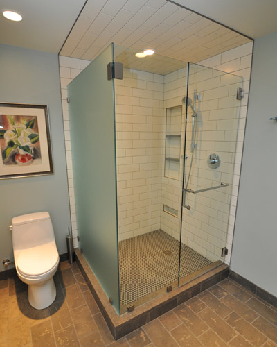 The floor tile is the same limestone as the counter slab'Lagos Blue--and the tile for the shower floor is an etched Ann Sacks penny tile in a medium grey tone.  The stone floors have an electric heat mat below to keep them toasty