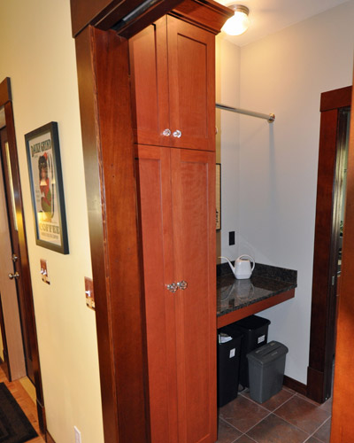 A convenient storage cabinet and folding counter on the other side of the washer