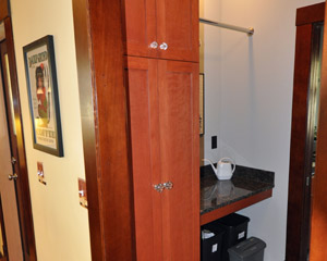 A convenient storage cabinet and folding counter on the other side of the washer