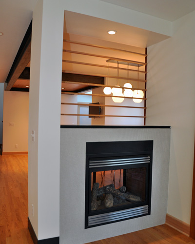 The other side of fireplace also had a makeover, with a full sheetrock wrap, steel detailing and subtle but beautiful tile. 'Note the blackened steel baseboards that wrap around the end