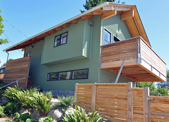 The entry to the studio is a mix of corrugated metal and Cumaru siding.  Fencing helps maintain privacy