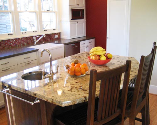 The cabinets include a built-in microwave and appliance garage. A full pantry cabinet is hidden in the far corner, Seattle kitchen remodel