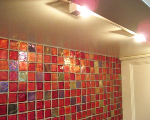 A peek under the upper cabinets reveals under-cabinet task lighting for the counter, custom tile backsplash Seattle