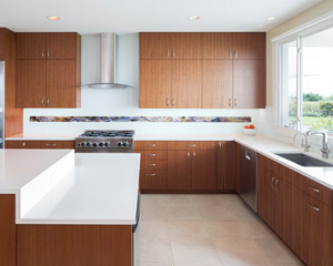 The kitchen features custom quartered walnut cabinets with lush wood tones and ample storage opportunities