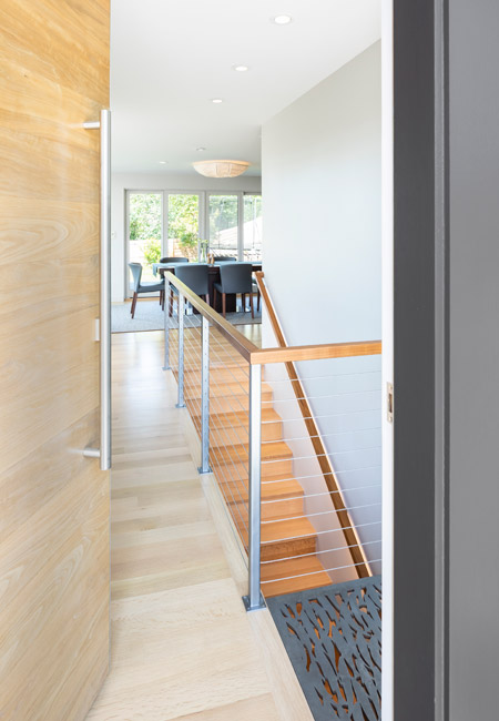 entryway with artwork over stairway