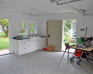 Inside the garage, there is ample space for two cars, plus a dedicated area for shop work and other projects, including a work sink area perfect for home brewing.  The opposite wall is home to all the mechanical equipment, including the tankless hot water heater, which provides both domestic hot water and heated water for the radiant heating in floor.  There is also an electric car charging station and an easy-to-use slot for a generator if needed