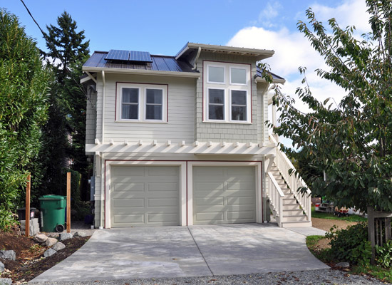 Solar panels on the West and East dormer roofs bring in electricity that can be used when someone's staying in the cottage, and sold back to Seattle City Light when it's not needed. The cottage functions as a comfortable space away from the house when guests visit, and provides bonus space for the family, while echoing the design details of the older home