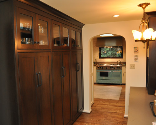 That hall is now lined with full-height cabinets and a desk area that leads into the spacious new kitchen and an eye-popping Blue Star range